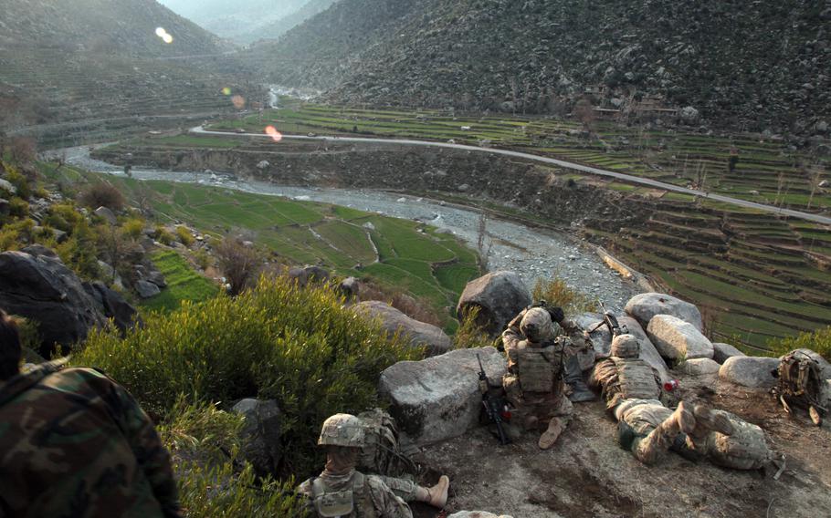 Soldiers with 1st Platoon, Company B, 2nd Battalion, 27th Infantry Regiment, scan the mountains