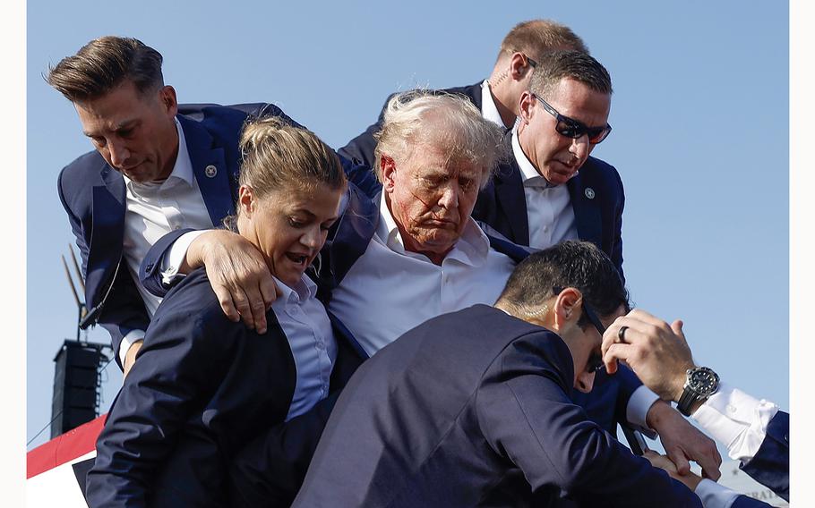 Republican presidential candidate former President Donald Trump is rushed offstage by Secret Service agents after being grazed by a bullet during a campaign rally on Saturday, July 13, 2024, in Butler, Pennsylvania. 