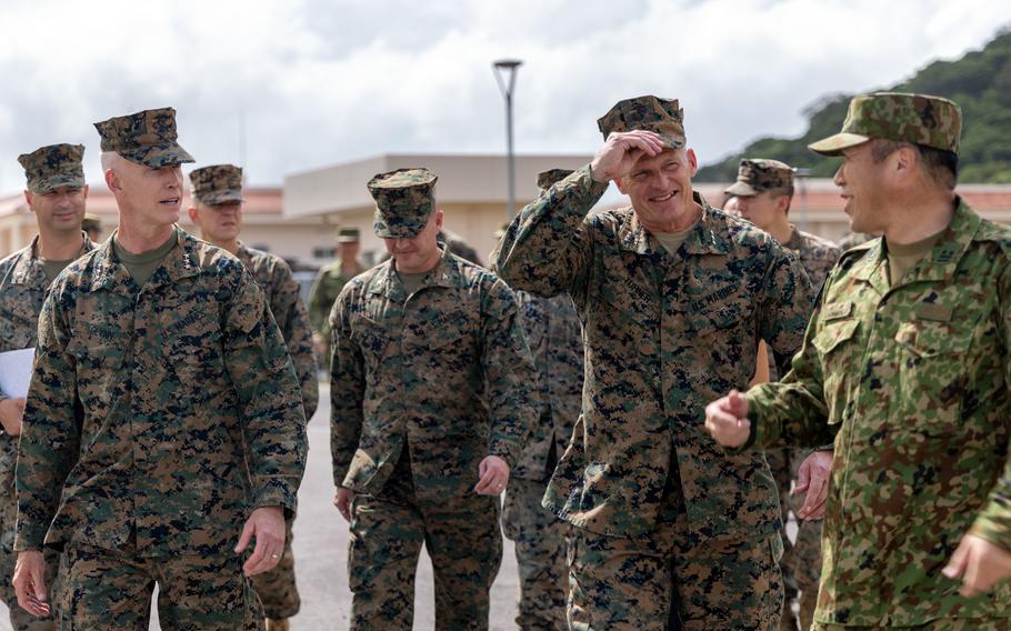 Lt. Gen. James Glynn and Lt. Gen. Roger Turner walk with a group of Marines at Camp Ishigaki in Japan.