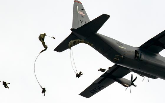 Paratroopers jumping out of a plane.