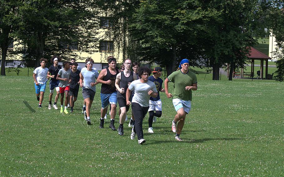 The Vilseck football team goes for a run during their first practice of the new season in Vilseck, Germany, on Monday, Aug. 5, 2024.