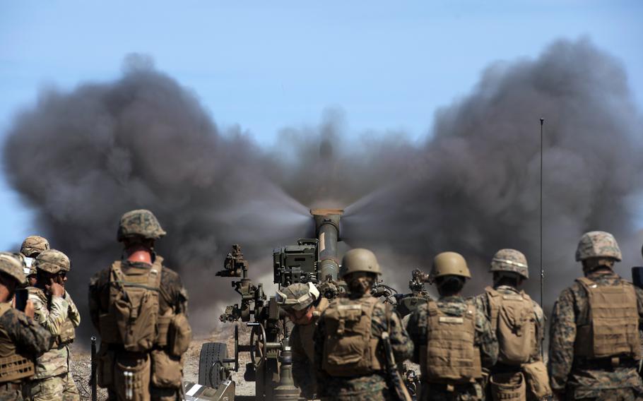 Marines fire an M-777 howitzer 