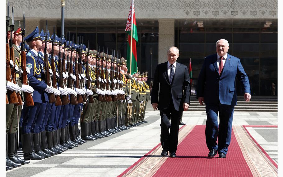 Russian President Vladimir Putin and Belarusian President Alexander Lukashenko walk past members of an honor guard during a welcoming ceremony in Minsk, Belarus, on May 24, 2024. 