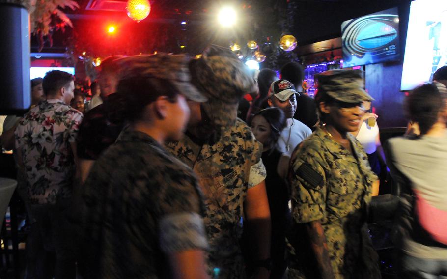 U.S. Marines patrol American Village bars in Chatan, Okinawa, Aug. 2, 2024.