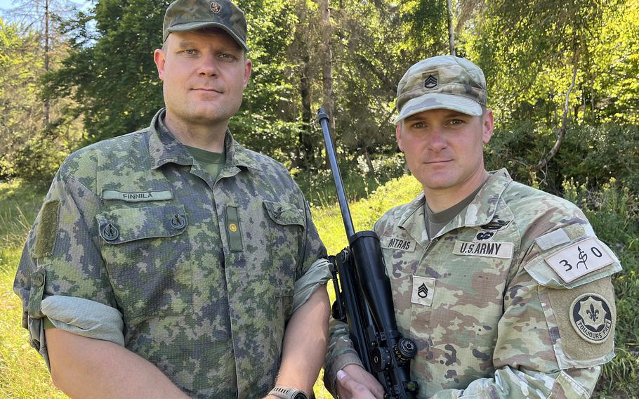 Army Staff Sgt. John Poitras, right, a squad leader with the 2nd Cavalry Regiment, partnered with Finnish Maj. Matti Finnila for the eighth annual European Best Sniper Team Competition that wrapped up Aug. 11, 2024, at the Joint Multinational Readiness Center in Hohenfels, Germany.