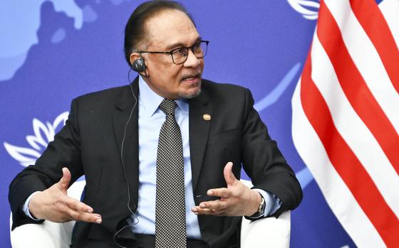 Malaysia's Prime Minister Anwar Ibrahim gestures while speaking to Russian President Vladimir Putin on the sidelines of the Eastern Economic Forum in Vladivostok, Russia, Wednesday, Sept. 4, 2024. (Kristina Kormilitsyna, Sputnik, Kremlin Pool Photo via AP)