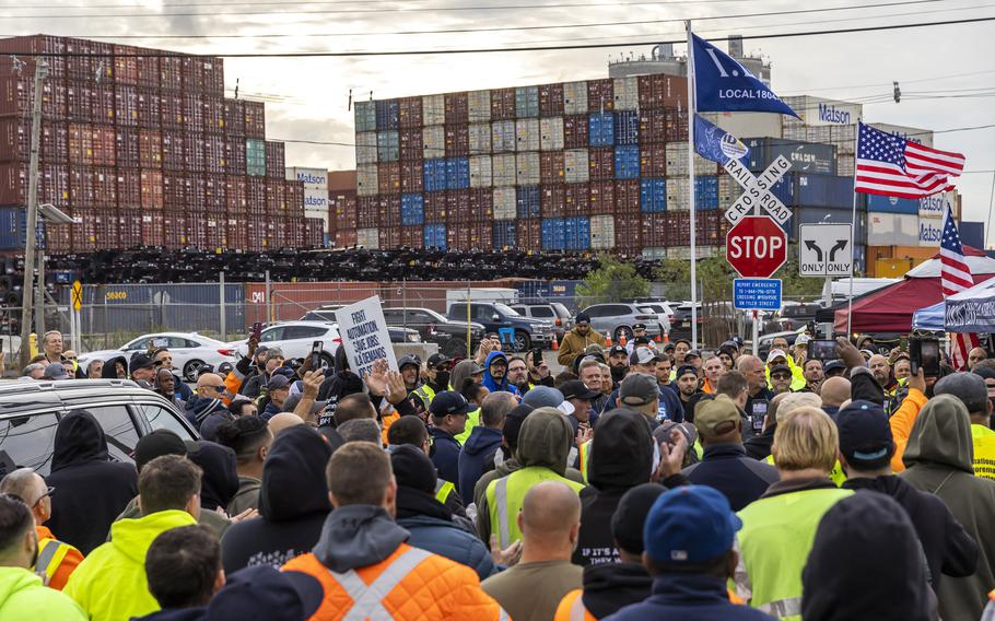 Striking workers hold picket signs at Port Newark in Bayonne, N.J. 