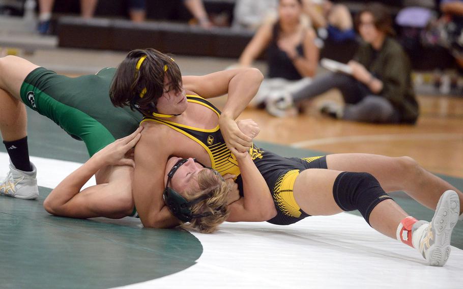 Kadena 145-pounder Peyton Allen locks in a head-and-arm hold on Kubasaki's Brady Potter during Wednesday's Okinawa wrestling dual meet. Allen pinned Potter in 54 seconds, and the Panthers won the meet 35-26 to go 2-0 on the season.