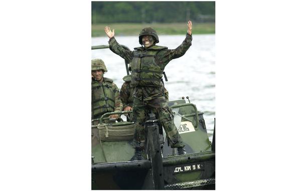 Hed: Officer initiation river dunk, 2001

Seoul, South Korea, June 15, 2001: 2nd Lt. Rose Guerrero, 2nd Platoon Leader, 50th Engineer Company-Assault Float Bridge, smiles after emerging from the Han River after being in charge of her 1st bridge completion.
After the bridge was completed, a few new officers got their initiation to the company when their soldiers tossed them in the river. 
The 50th Engineer Company at Camp LaGuardia, South Korea, were building a floatable bridge across the wide river with the help of a South Korean reserve battalion. 

Read the article in the bridge building exercise and see additional photos here. 

META TAGS: South Korea; U.S. Army; South Korean army; ROK; multi-national training; Korean-American relations; 50th Engineer Company