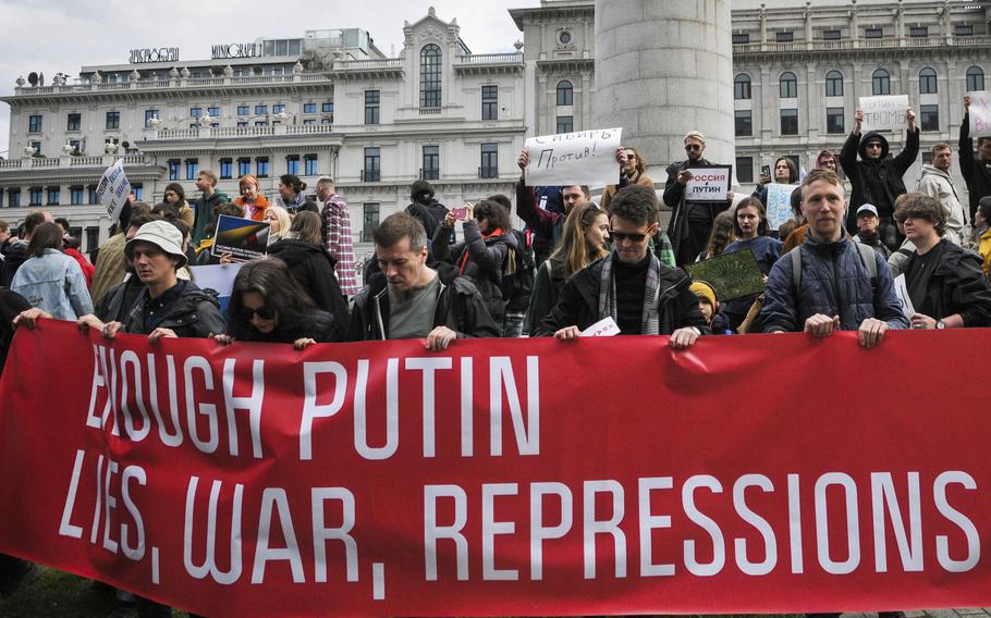 Anti-Putin protestors in Georgia’s capital, Tbilisi, carry a red banner that reads “Enough Putin lies, wars, repressions,” March 17, 2024.