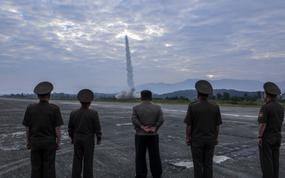 North Korean leader Kim Jong Un, center, and military officials watch at missile launch in this image from the state-run Korean Central News Agency on Sept. 19, 2024.