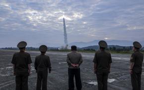 North Korean leader Kim Jong Un, center, and military officials watch at missile launch in this image from the state-run Korean Central News Agency on Sept. 19, 2024.