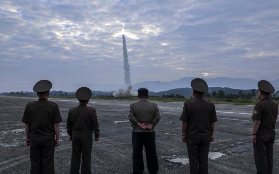 North Korean leader Kim Jong Un, center, and military officials watch at missile launch in this image from the state-run Korean Central News Agency on Sept. 19, 2024.