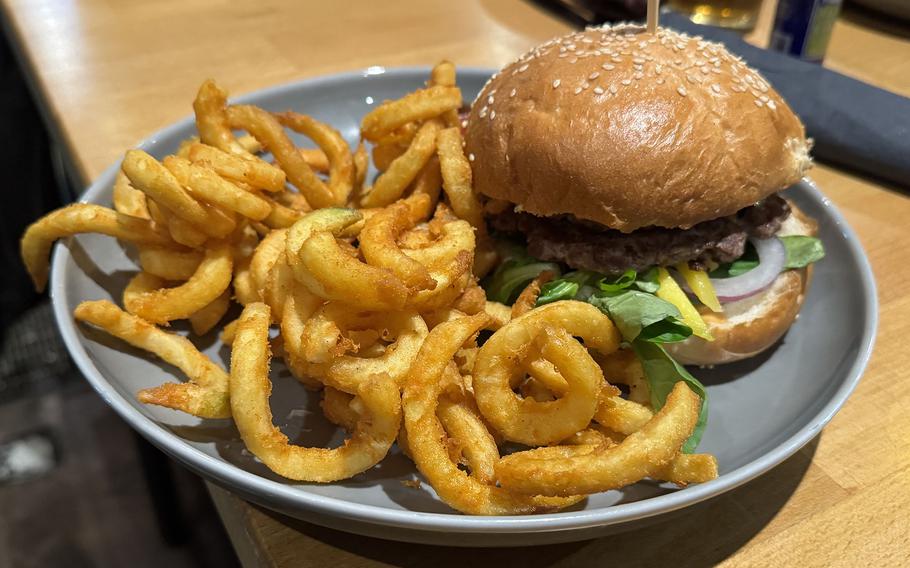 A burger and fries on a plate.