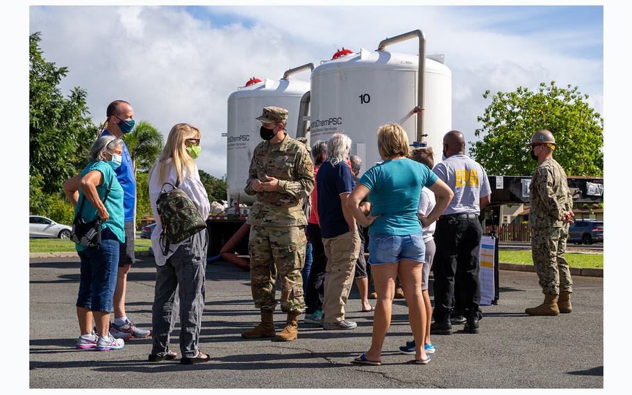 Military personnel explain the flushing process and the restoration of drinking water with the residents of the affected Joint Base Pearl Harbor-Hickam  housing communities on Dec. 29, 2021. 