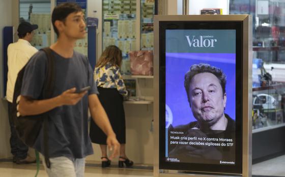 An ad by Valor media shows a photo of Elon Musk at a shopping center in Brasilia, Brazil, Monday, Sept. 2, 2024. The sign reads in Portuguese: "Musk creates profile on X against Moraes to leak confidential decisions of the Supreme Court," referring to Supreme Court Justice Alexandre de Moraes who ordered the platform blocked for having failed to name a local legal representative as required by law. (AP Photo/Eraldo Peres)