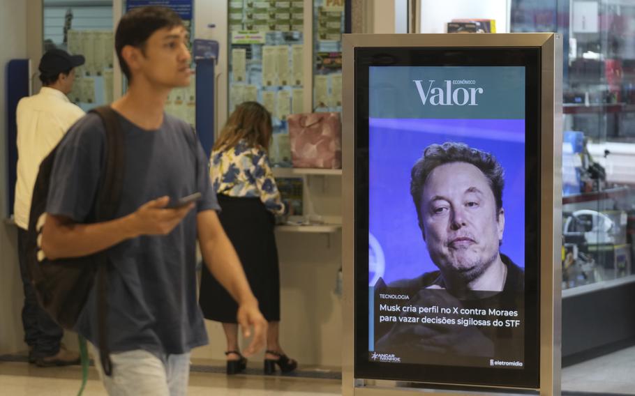 An ad by Valor media shows a photo of Elon Musk at a shopping center