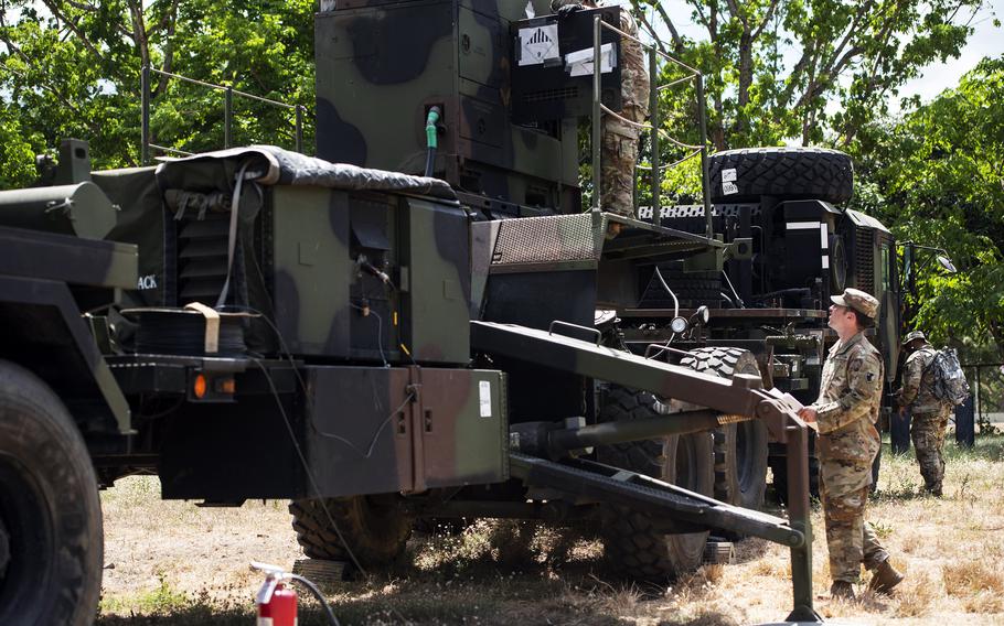 U.S. Army Spc. Rem Mendoza, left, Cpl. Christian Grantham, center, and Army Staff Sgt. Aaron Agsaoay, right, inspect a Patriot air-defense battery at Clark Air Base, Philippines, May 2, 2024.