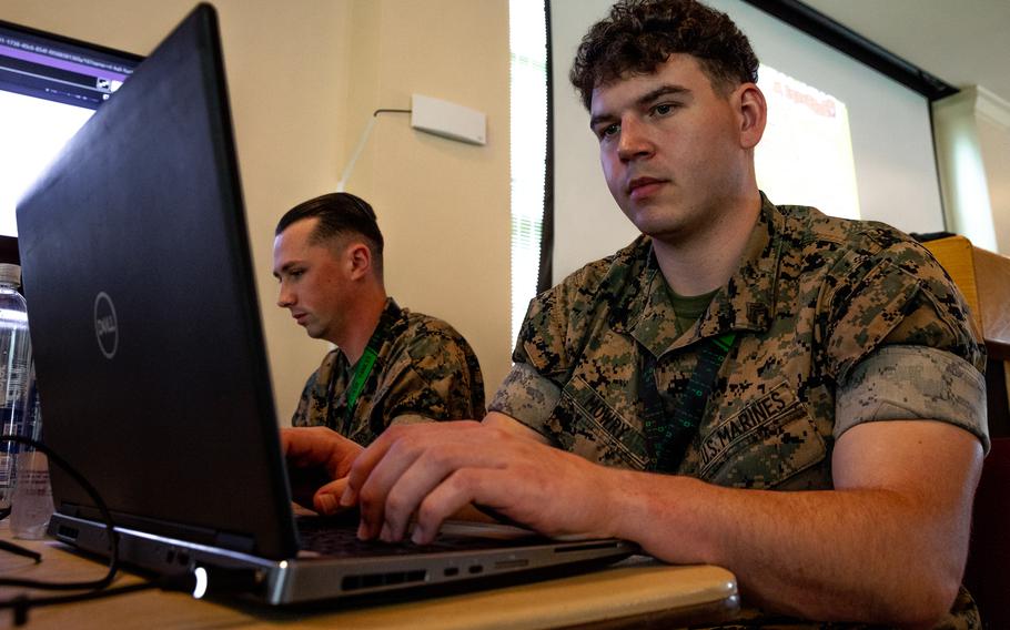 Marine Corps Cpl. Dakota Filyaw, left, and Cpl. Gabriel Mowry, right, cyberspace warfare operators assigned to the 8th Communication Battalion, work on computers at Camp Nett in Niantic, Conn., June 16, 2022. The Marine Corps is the only branch without any service obligations after cyber training, which is often over a year long and costs the military hundreds of thousands of dollars per person. 