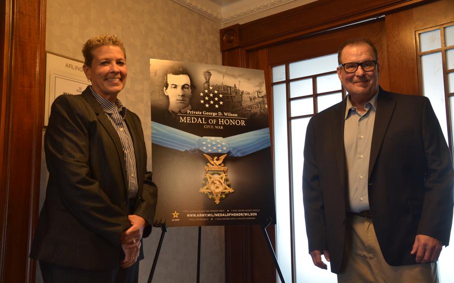 Kimberly Chandler, left, and Scott Chandler, right, standing next to a photo of their great-great-great grandfather Pvt. George Wilson on July 2, 2024. Wilson and Pvt. Philip Shadrach, Union soldiers during the Civil War, will be awarded the Medal of Honor on July 3, 2024, becoming the last of the Andrews’ Raiders to receive the award.