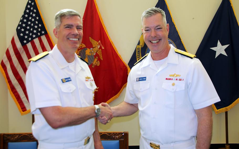Rear Adm. Derek Trinque, left, congratulates Rear Adm. Christopher Stone following the Task Force 76/3 change-of-command ceremony at the Camp Courtney Chapel on Okinawa, Friday, June 9, 2023.