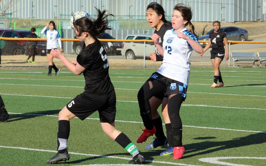 Leilani Rice and Grace Williams play the ball.