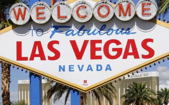 The famous "welcome" sign in Las Vegas draws lines of people waiting to take photos.