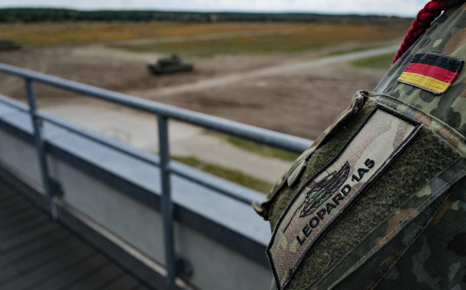 A German trainer overlooks the range as Ukrainian soldiers fire tank rounds during an exercise on June 13, 2024, at Klietz training range, Germany. 