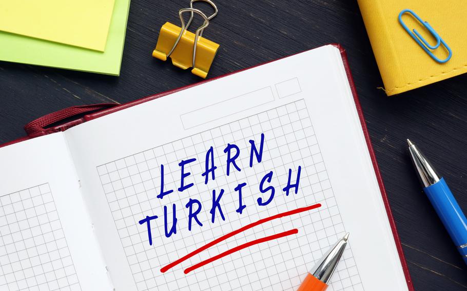 The words “Learn Turkish” written in a notebook