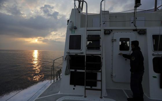 FILE - In this Friday March 17, 2017 file photo, the sun rises as a Greek coast guard vessel patrols on the Aegean Sea near the northeastern Greek island of Lesbos. Greece's prime minister Kyriakos Mitsotakis says on Thursday, Sept. 30, 2021, he is "unapologetic" in defending Greece's borders in the face of uncontrolled migration attempts, but insists his country is doing so in a manner that respects human rights. (AP Photo/Thanassis Stavrakis, File)