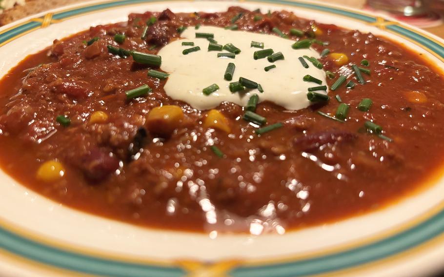 A bowl of chili topped with creme fraiche