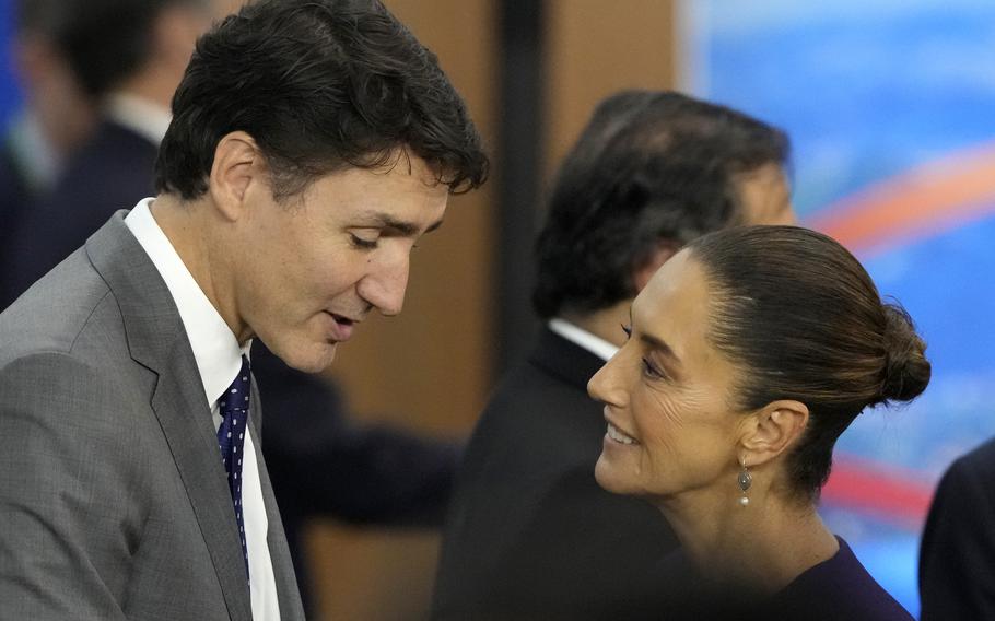 Canada’s Prime Minister Justin Trudeau, left, and Mexico’s President Claudia Sheinbaum talk during the G20 Summit leaders meeting in Rio de Janeiro, Monday, 