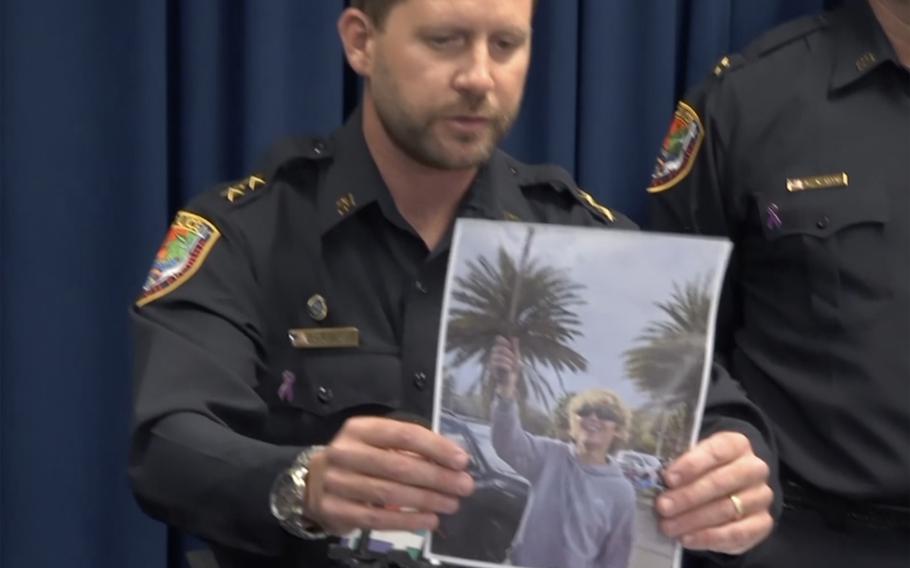 The police chief of Neptune Beach holds a photo of the 18-year-old Trump supporter that brandished a machete at a polling location.