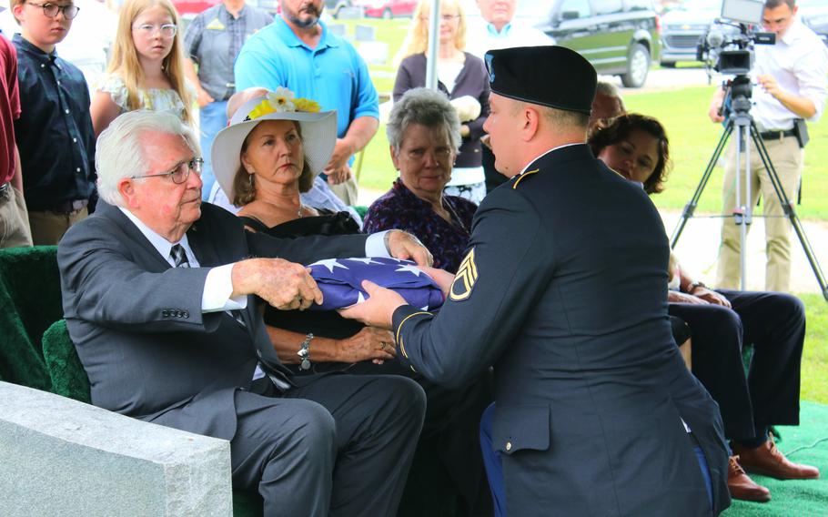 An American flag is presented June 14, 2023, to Staff Sgt. Ralph D. Kolb’s nephew, Harold Kolb Jr., at a military funeral in McGehee, Ark. Kolb was killed Aug. 1, 1943, when his bomber was hit by anti-aircraft fire and crashed in Ploesti, Romania.