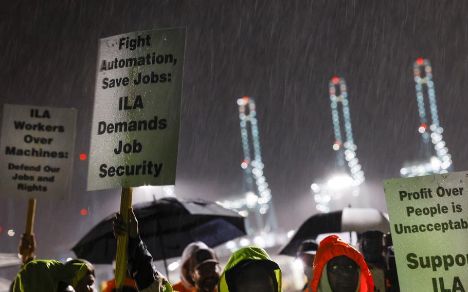 Dockworkers carry picket signs in Portsmouth, Va.