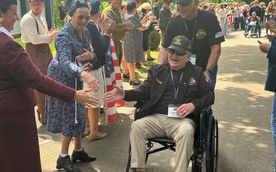Veteran Charlie Baldwin beams as he passes a crowd of well-wishers from the Normandy commune of Houlgate, France, who turned out to greet veterans passing through on Monday, June 3, 2024, to attend the D-Day commemorations.