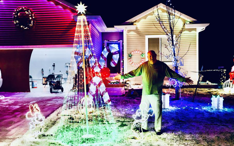 John Reichart in front of his own decorated home in Indianola, Iowa. 