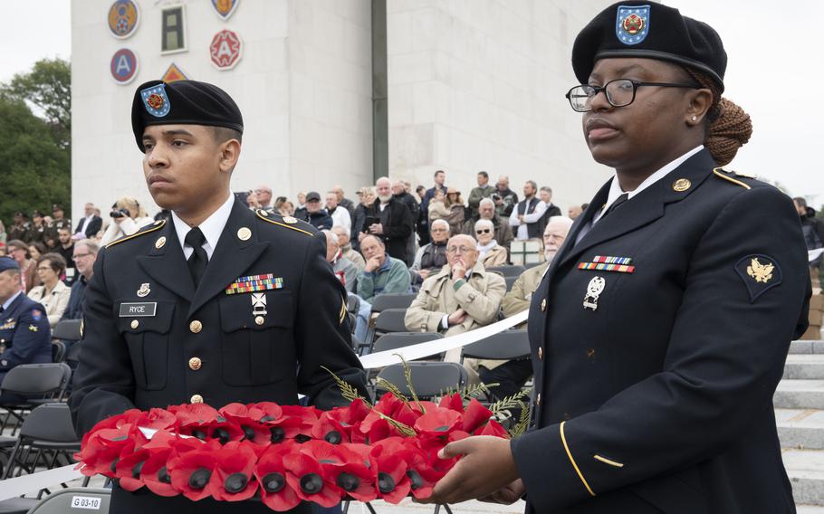 Cpl. Isaiah Ryce, left, and Spc. Tamara Laurent, who support U.S. Army Garrison Benelux, lay wreaths during a Memorial Day ceremony at Ardennes American Cemetery in Neupré, Belgium, on May 25, 2024.