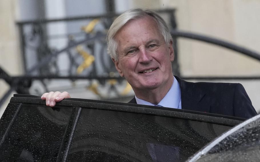 French Prime Minister Michel Barnier boards a car