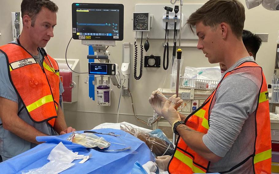 Two soldiers practice critical care on a mannequin during a training course about how to evaluate medical facilities, including field hospitals, to meet NATO standards.