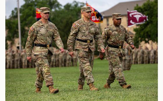 Lt. Gen. Sean C. Bernabe, III Armored Corps Commander, Maj. Gen. Monté  L. Rone, and Maj. Gen. John V. Myer III march during the inspection of troops on Cavalry Parade Field, Fort Riley, Kansas June 28, 2024. Maj. Gen. Meyer is relinquishing command of the 1st Infantry Division to Maj. Gen. Rone. (U.S. Army photos by Pfc. Joshua Fish)