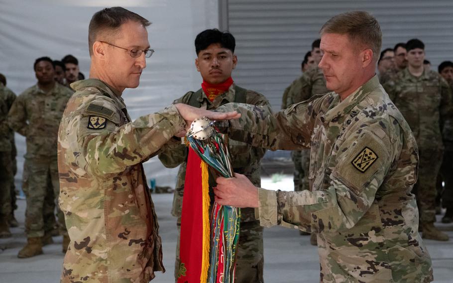 Soldiers case the unit’s colors.