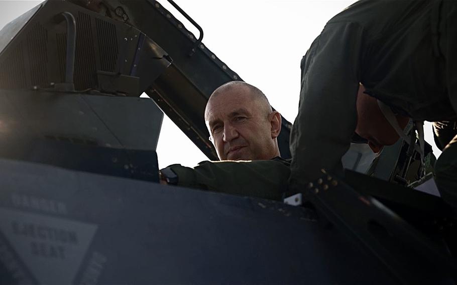 The president of Bulgaria looks out of the cockpit of an F-16.