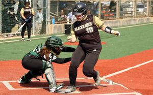 Humphreys' Charlotte Langley crosses home plate ahead of the tag by Daegu's Aneya Aldan.