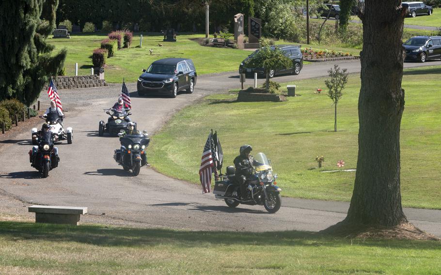 Motorcycles lead a funeral procession for U.S. Army Pvt. Billy E. Calkins