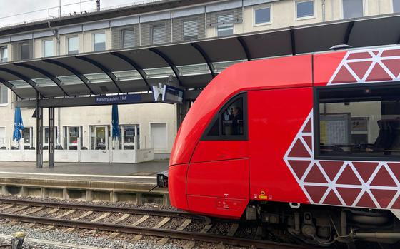 A train picks up passengers at the Kiaserslautern, Germany, main train station.