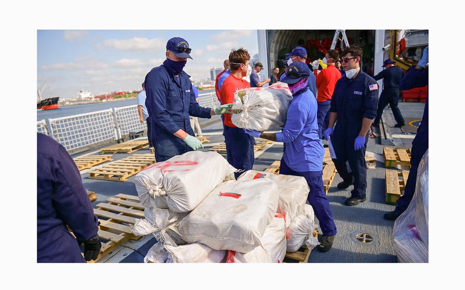 U.S. Coast Gaurd Cutter Mohawk (WMEC 913) crew members stack bales of illegal narcotics on the flight deck of the cutter during a drug offload at Port Everglades in Fort Lauderdale, Florida, on May 10, 2024. 