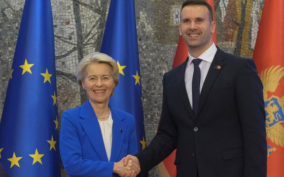 Montenegro's Prime Minister Milojko Spajic, right, shakes hands with European Commission President Ursula von der Leyen in Podgorica, Montenegro, Saturday, Oct. 26, 2024. (AP Photo/Risto Bozovic)