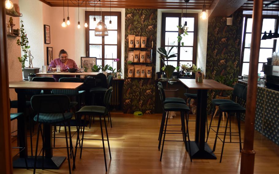 A customer sits in a sunny corner of Cafe AusZeit, in Kusel, Germany, on Sept. 17, 2024. The cafe's menu was inspired by the food of Thailand and South Korea.