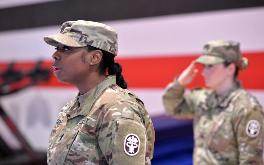 Sgt. 1st Class Chasidy Tenison sings the German and American national anthems at the Medical Readiness Command, Europe change of command ceremony in Sembach, Germany, Oct. 26, 2023, where Brig. Gen. Roger Giraud took over from Brig. Gen. Clinton Murray.